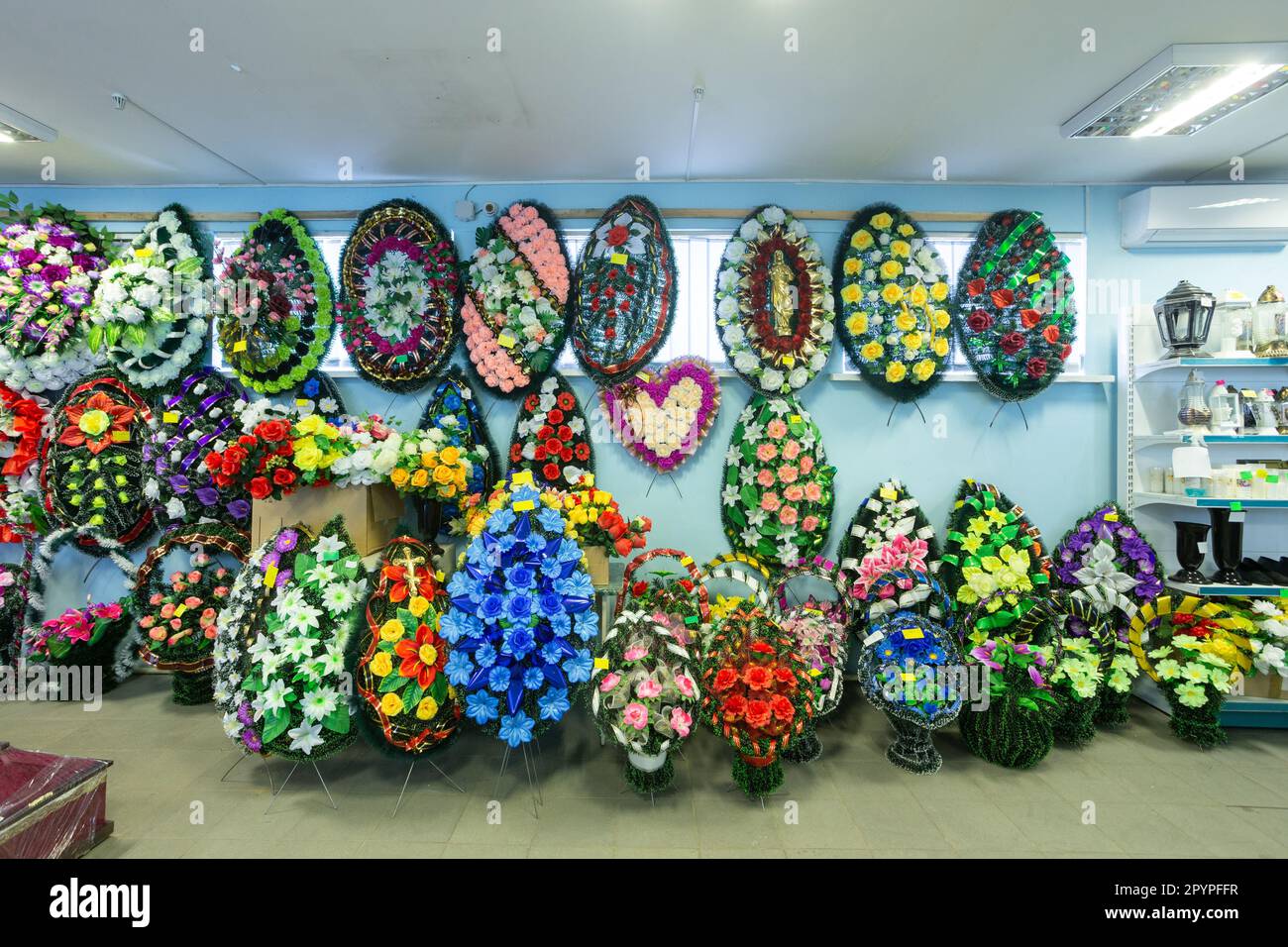 Interior of shop with funeral accessories. Shop selling coffins, funeral wreaths and flowers. Stock Photo