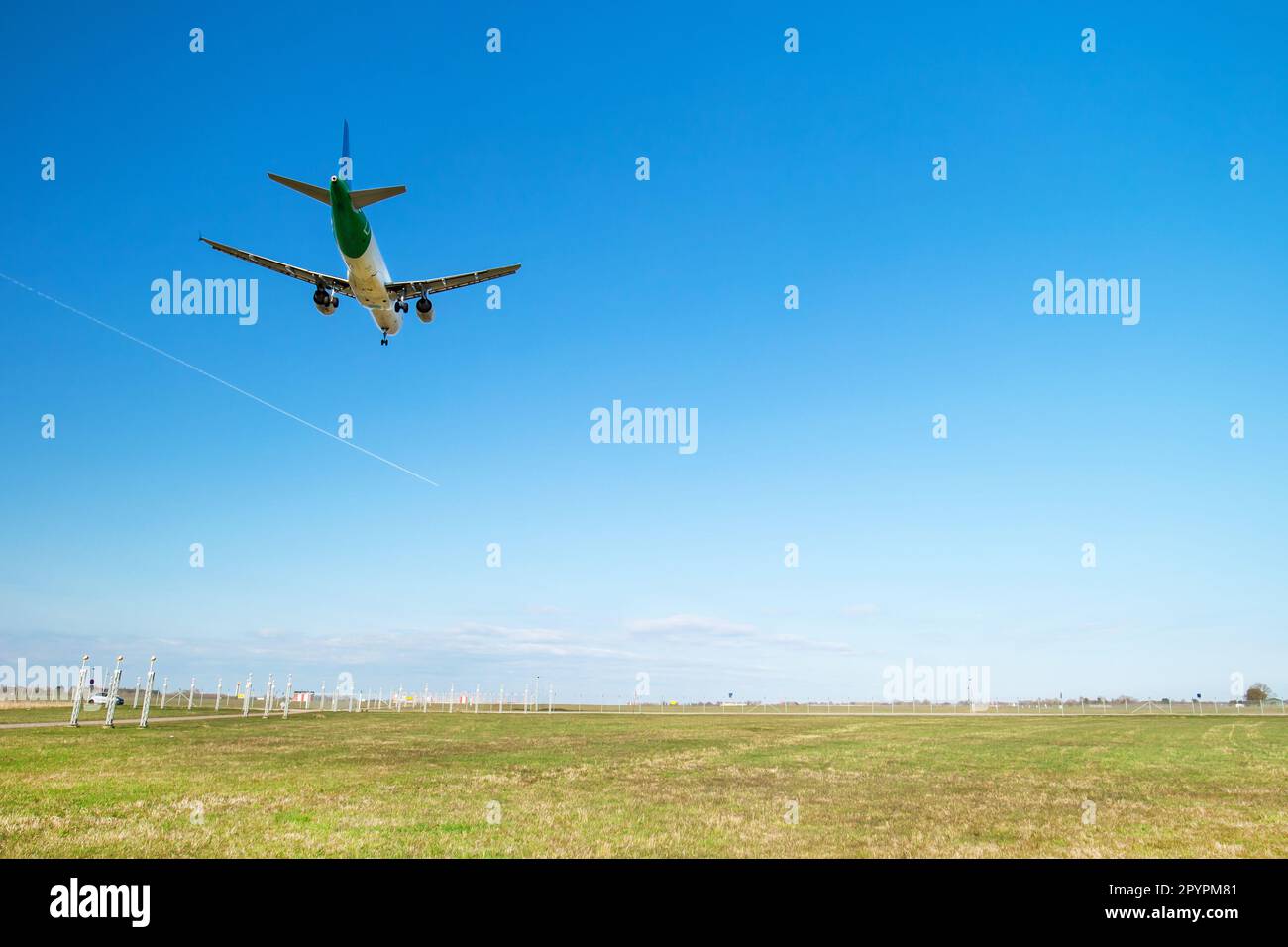 Landing of a commercial aircraft while aproaching airport Stock Photo