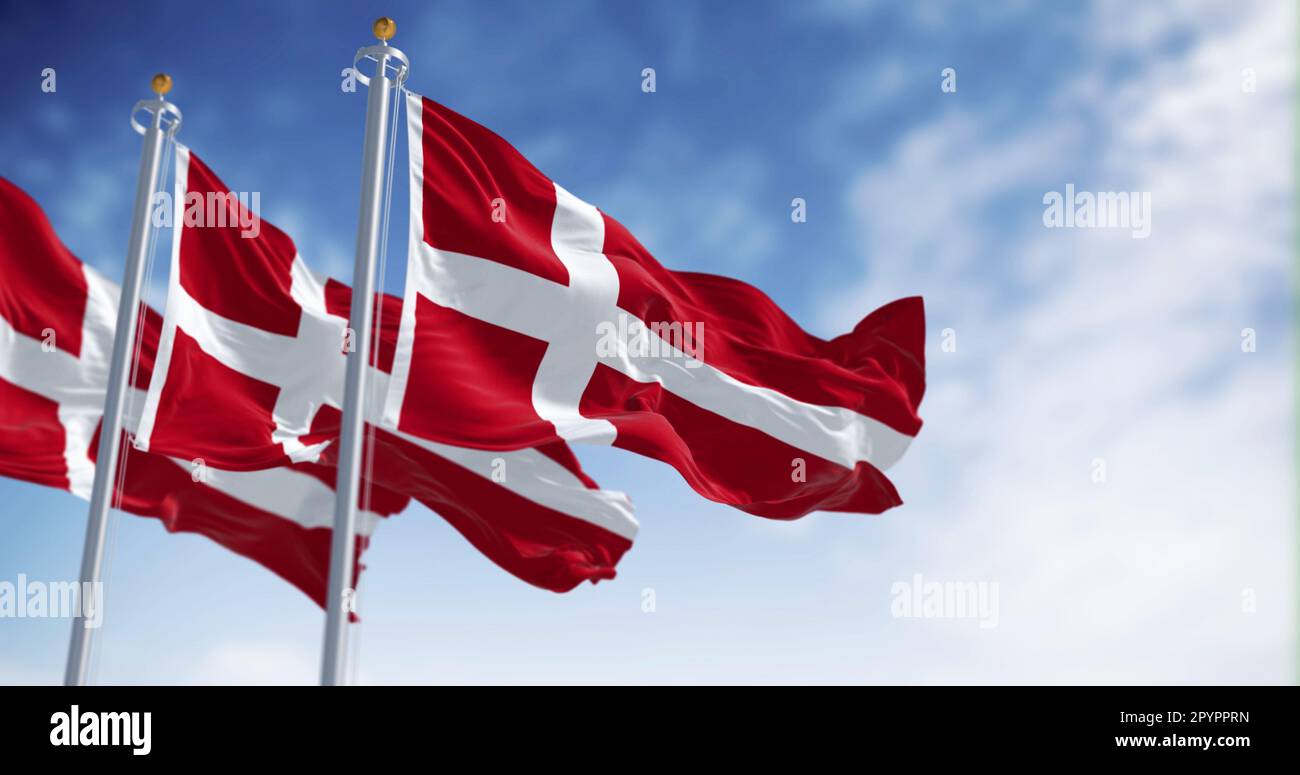 Three Denmark national flags waving in the wind on a clear day. The Kingdom of Denmark is a Nordic country in Northern Europe. Fluttering fabric. 3d i Stock Photo