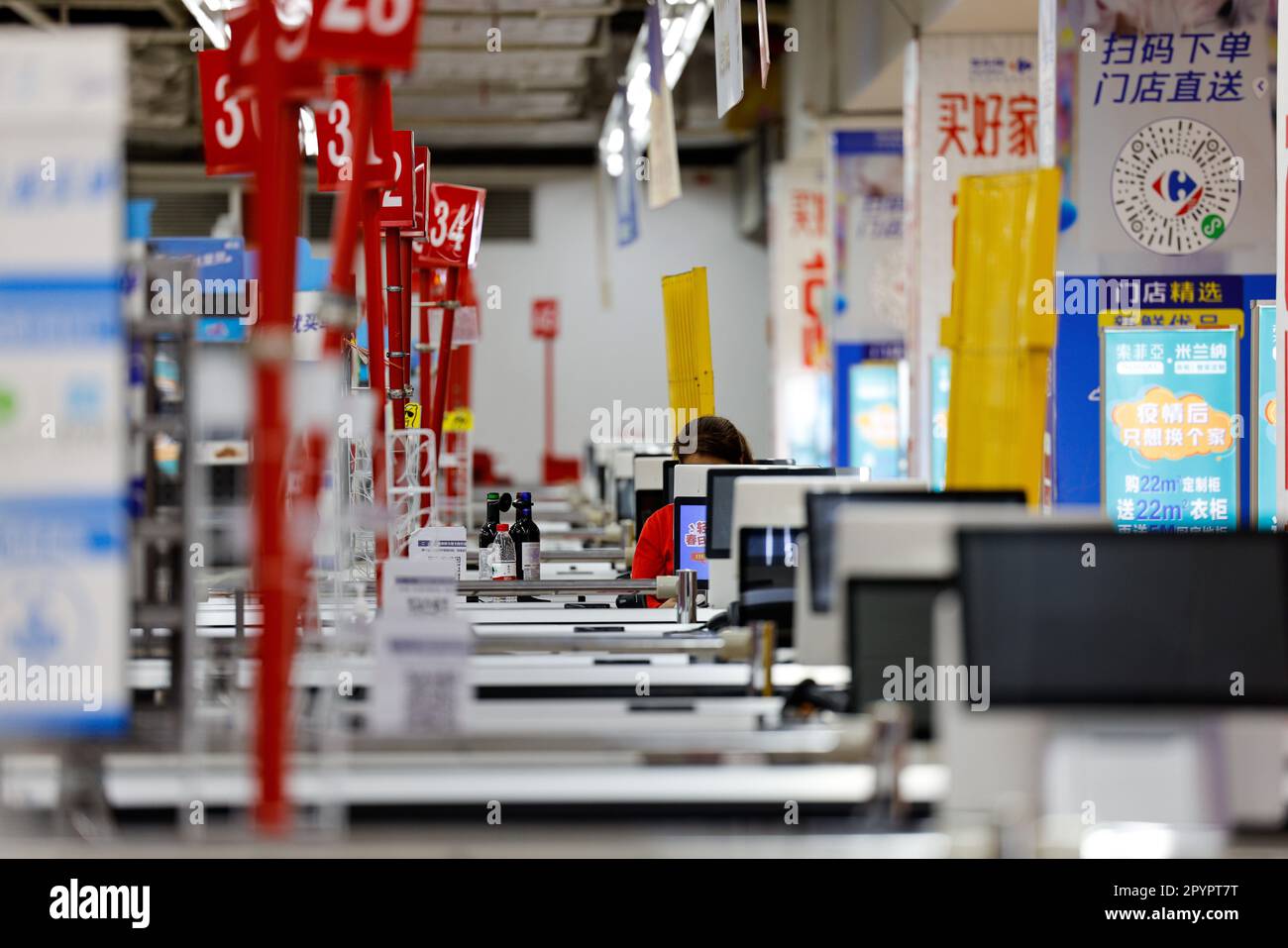 A view of a retail store with numerous checkout counters arranged in neat rows Stock Photo