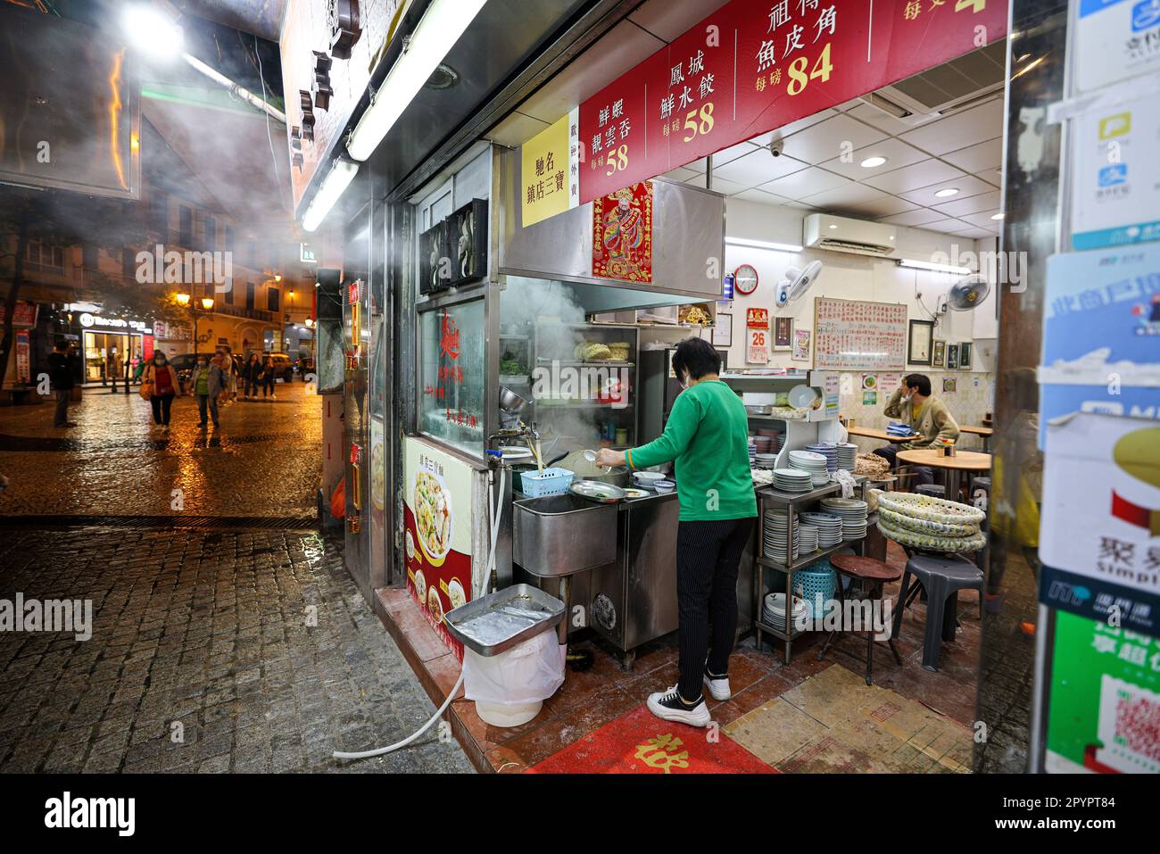 A vibrant street scene of night-time street food vendors in Hong Kong ...