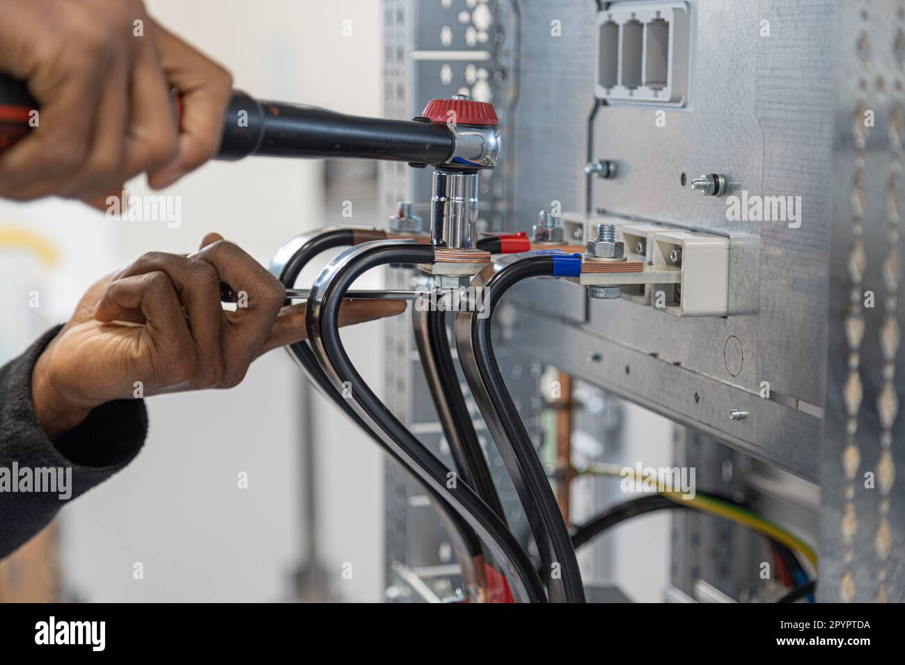 an electrician tightens a nut with a torque wrench Stock Photo Alamy