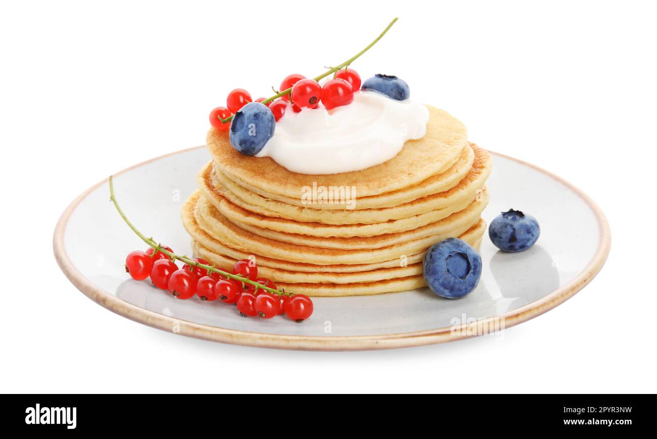 Tasty pancakes with natural yogurt, blueberries and red currants on white background Stock Photo