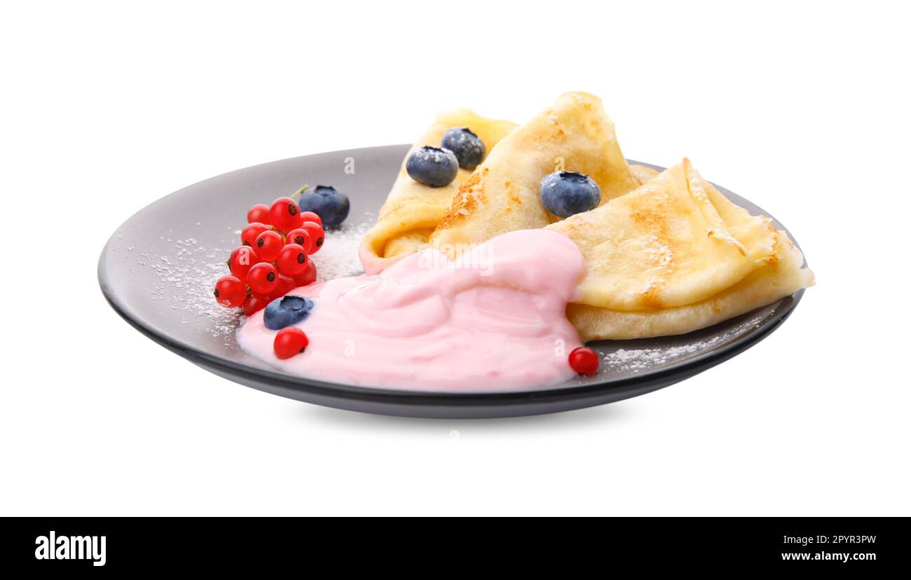 Delicious crepes with natural yogurt, blueberries and red currants on white background Stock Photo
