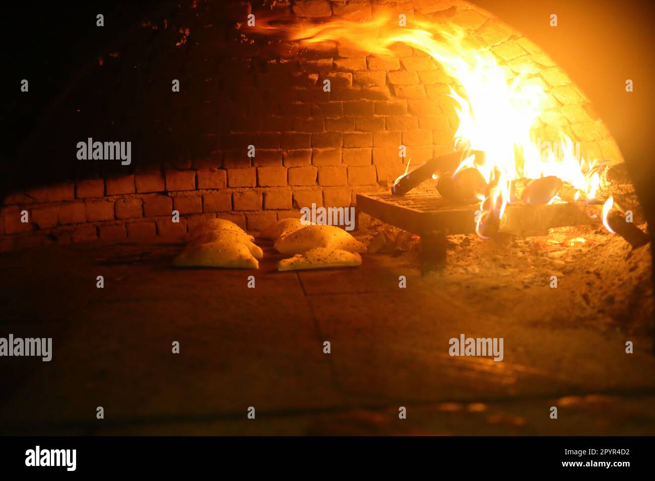 Old style middle east stone oven with flat bread with different spices