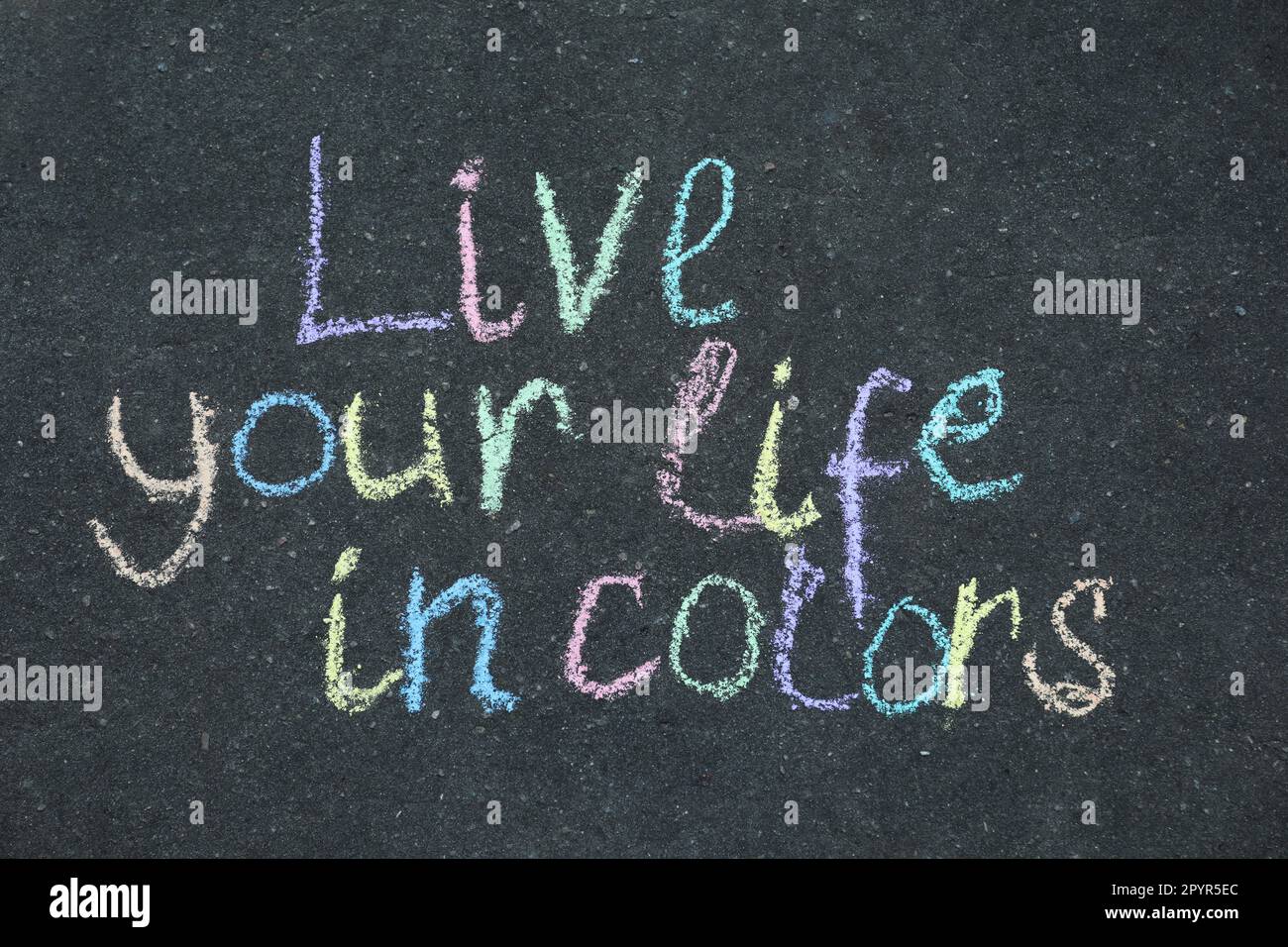Phrase Live Your Life In Colors written on asphalt, top view Stock Photo