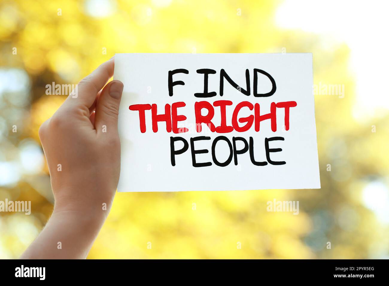 Woman holding card with phrase Find The Right People against blurred background, closeup Stock Photo