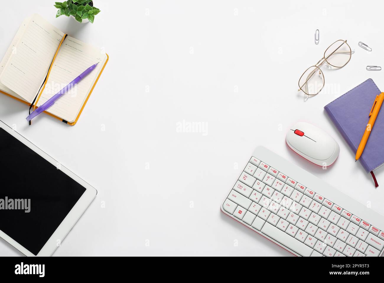 Composition with tablet computer, keyboard, notebook and glasses on white background Stock Photo