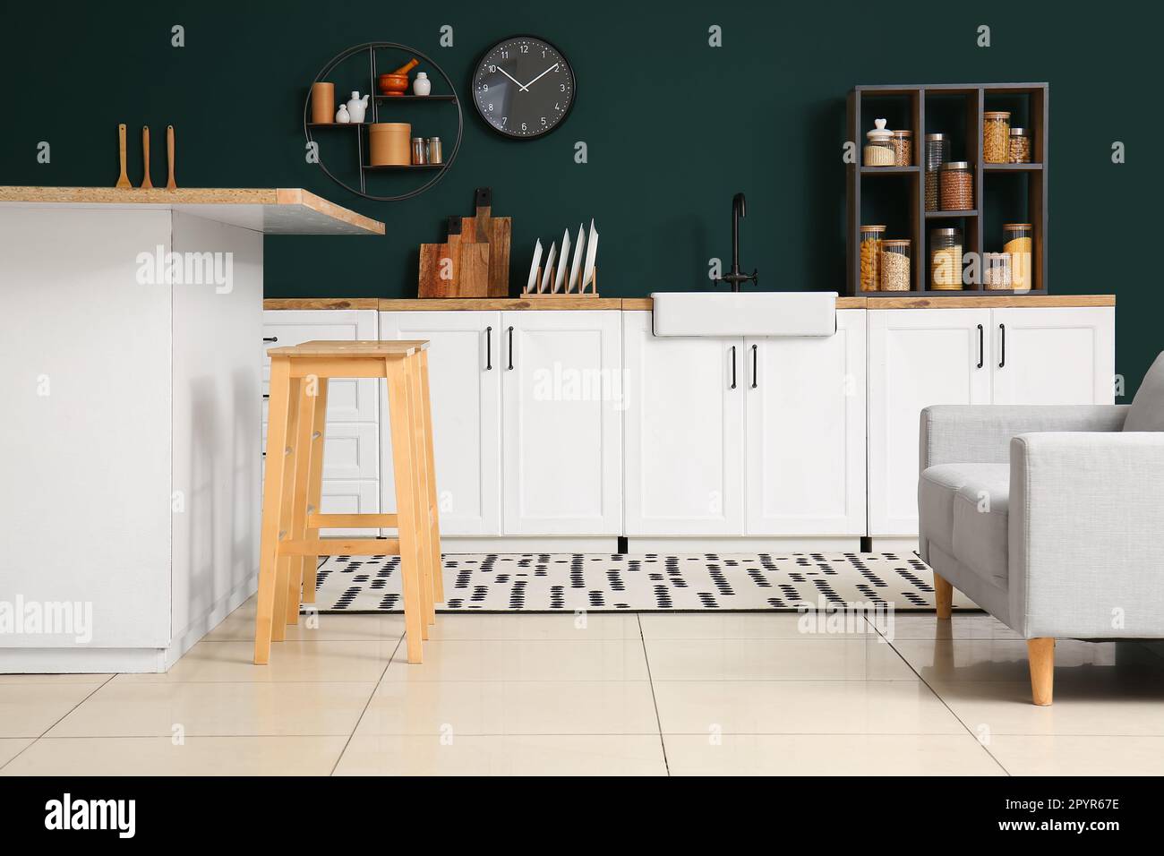 Interior of modern kitchen with white counters and cozy armchair Stock ...