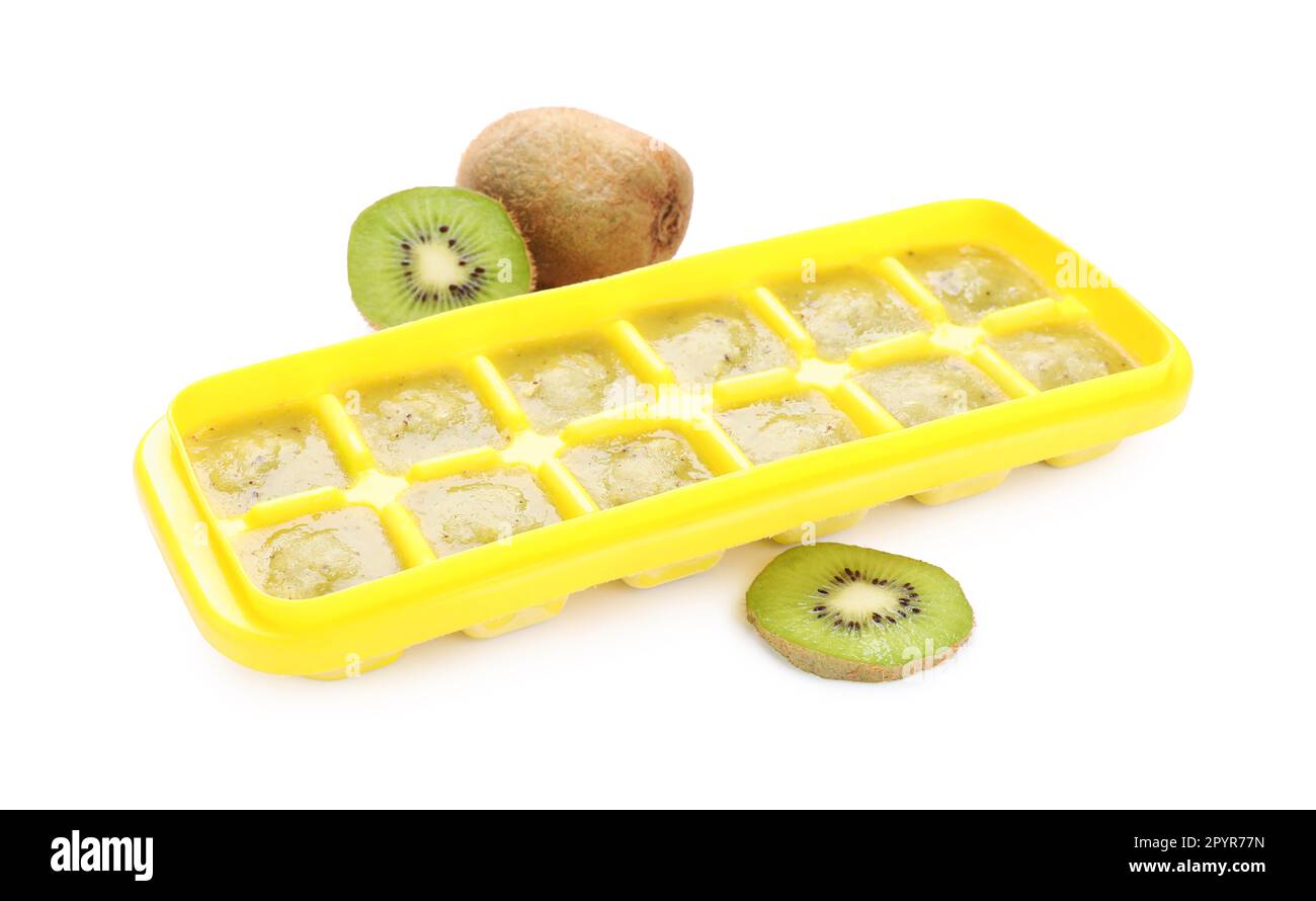 Kiwi puree in ice cube tray and fruits on white background. Ready for