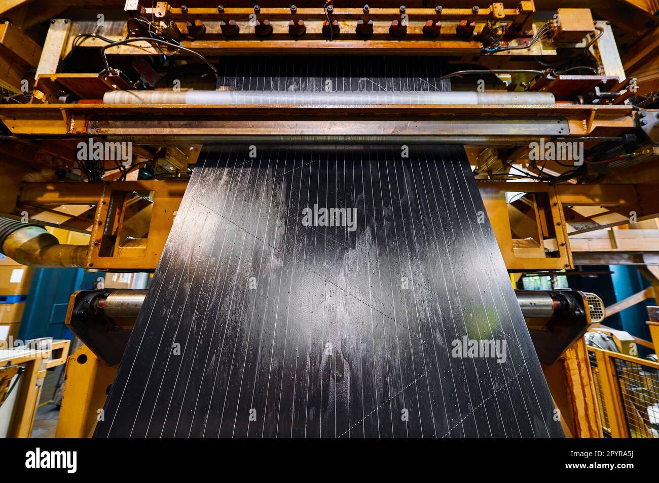Processing of reinforced rubber cord tape at production line Stock
