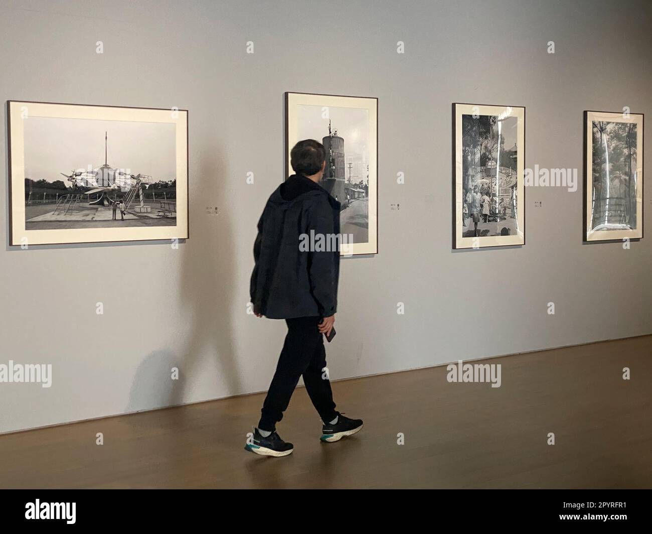 Beijing, China. 25th Apr, 2023. This mobile phone photo shows a man visiting Italian photographer Andrea Cavazzuti's 'At Eye Level' exhibition in One Art Museum in Beijing, capital of China, April 25, 2023. TO GO WITH 'Across China: Italian photographer's 'eye-level' view of China ' Credit: Luo Xin/Xinhua/Alamy Live News Stock Photo