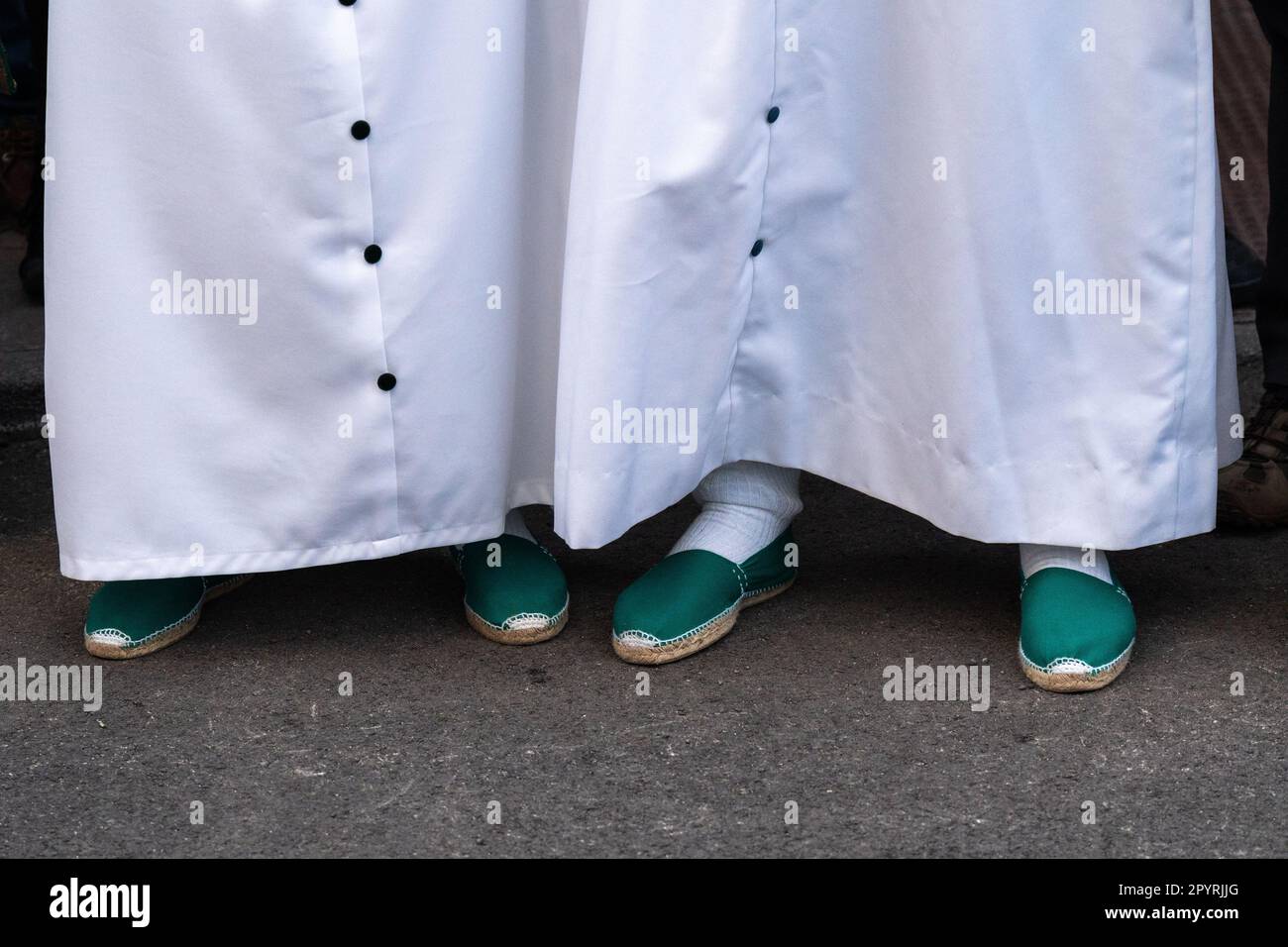 The green shoes of Nazarenos during a procession at Holy Week or Semana Santa, April 5, 2023 in Ronda, Spain. Ronda, first settled in the 6th century B.C. has been holding Holy Week processions for over 500-years. Stock Photo