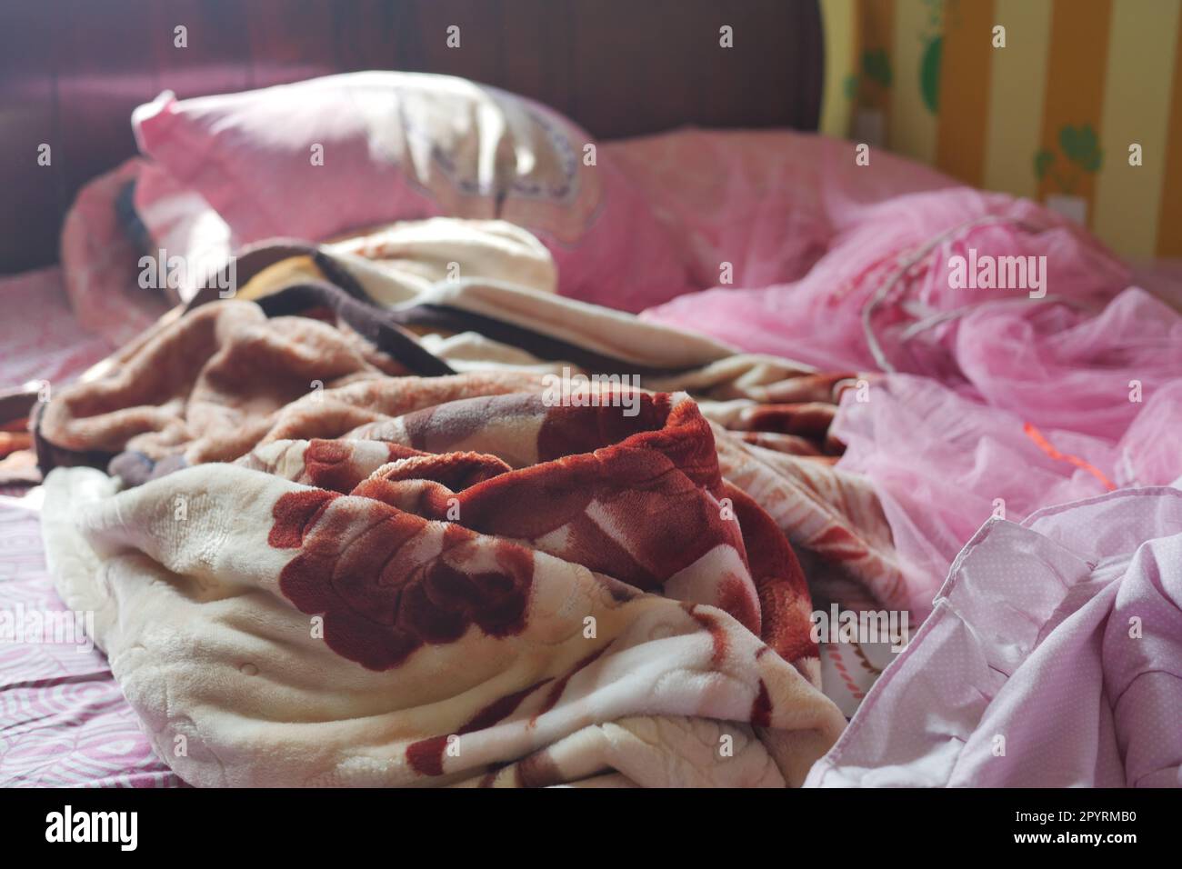 Bed with messy pick color Blankets, Stock Photo
