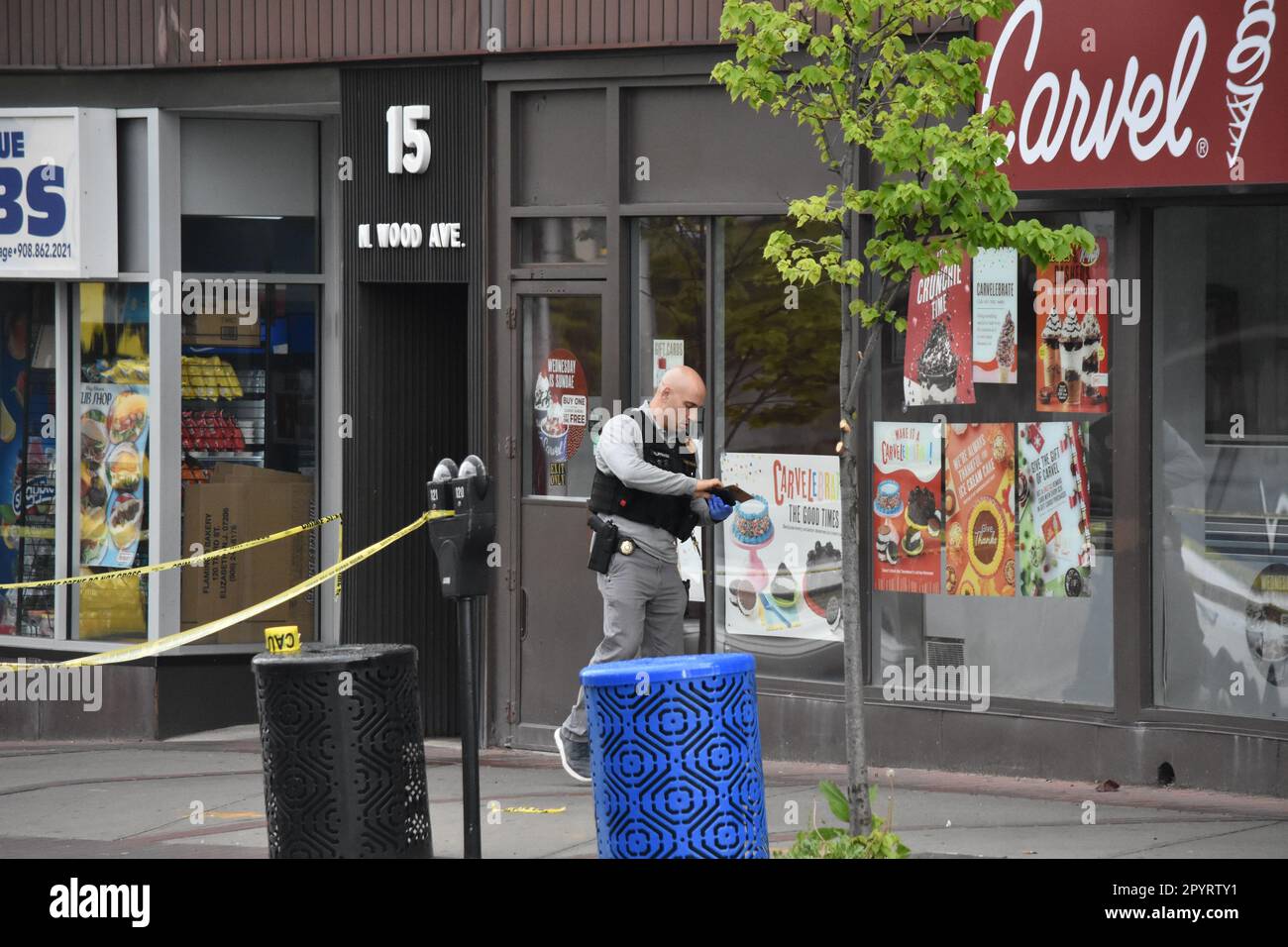 Linden, US, 04/05/2023, Police officers look for evidence at the crime scene. Bullet fragments