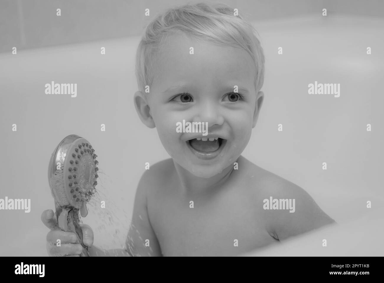 Child bubble bath. Pretty smiling little boy taking a bath with soap ...