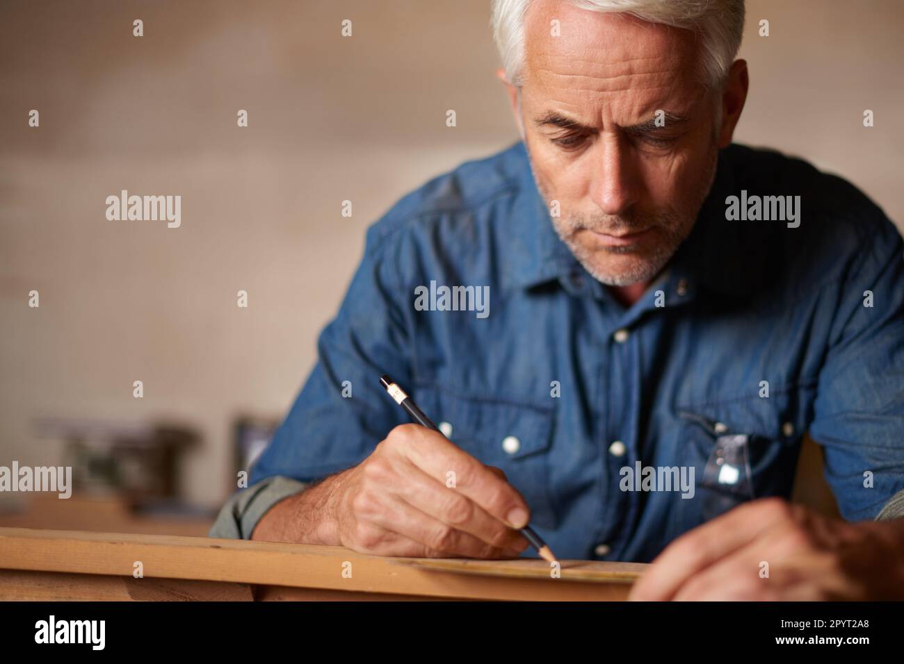 He knows everything there is to know about carpentry. a mature male
