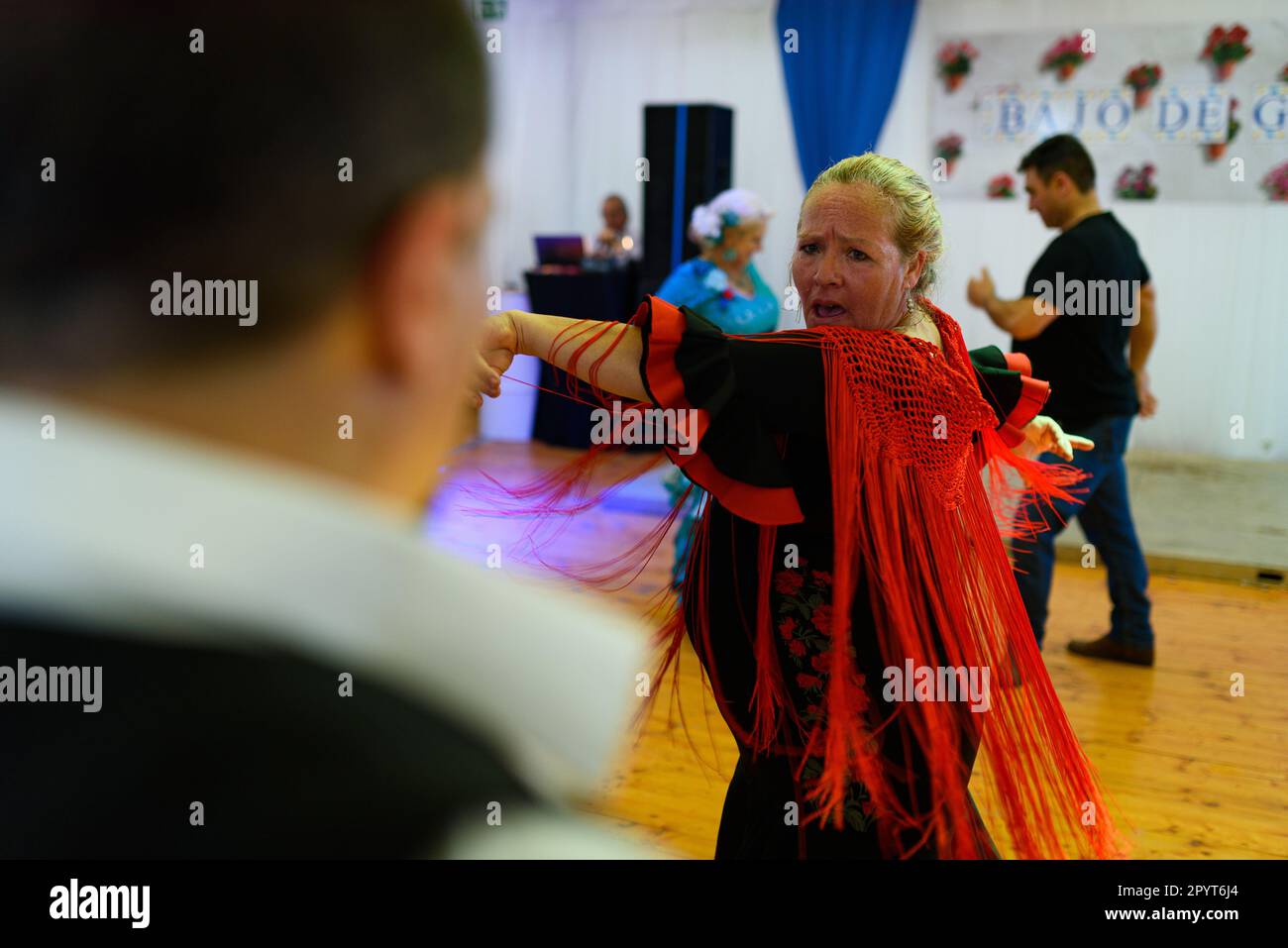 A woman in traditional andalusian dress is seen dancing flamenco during celebrations for the 'Feria de Abril' fair in the Forum Park. The fair, know a Stock Photo