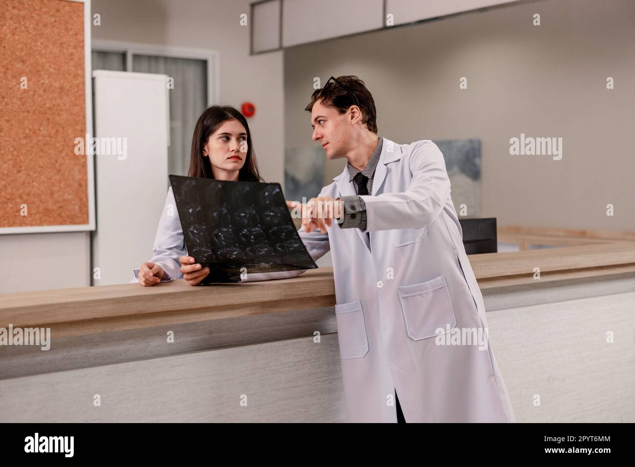 Physician and radiologist analyze medical images, including MRI film ...