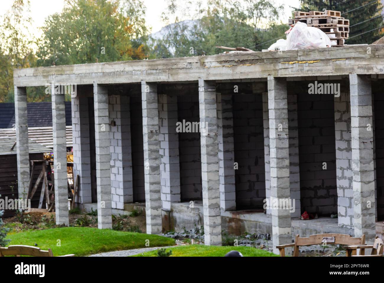 Building Site With House Under Construction. Small and affordable