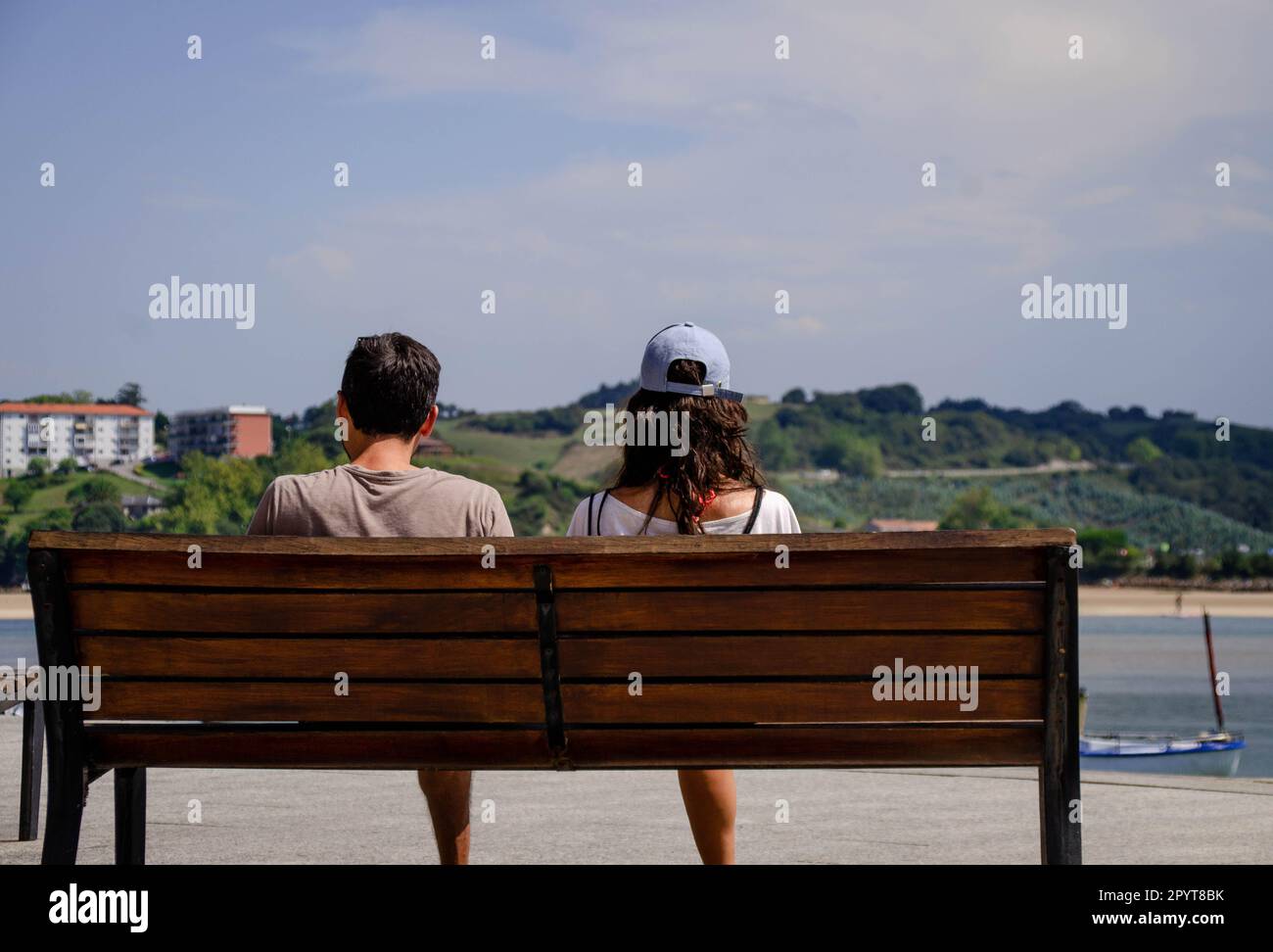 Picture of View from Behind of a Heterosexual Couple Sitting on a Bench ...