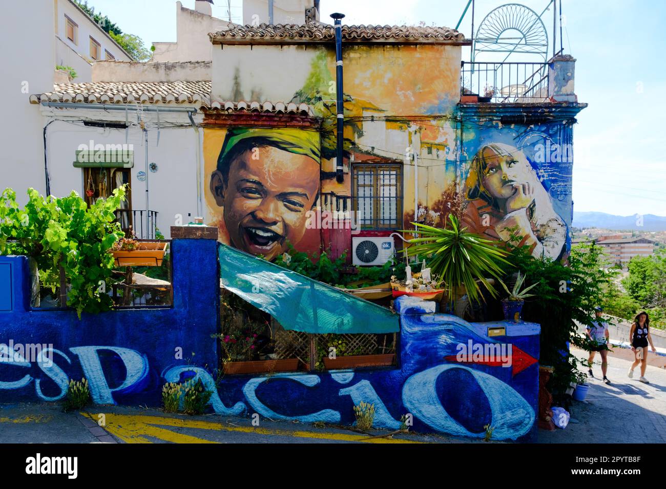 Street art by El Nino de las Pinturas in Granada city, Spain Stock