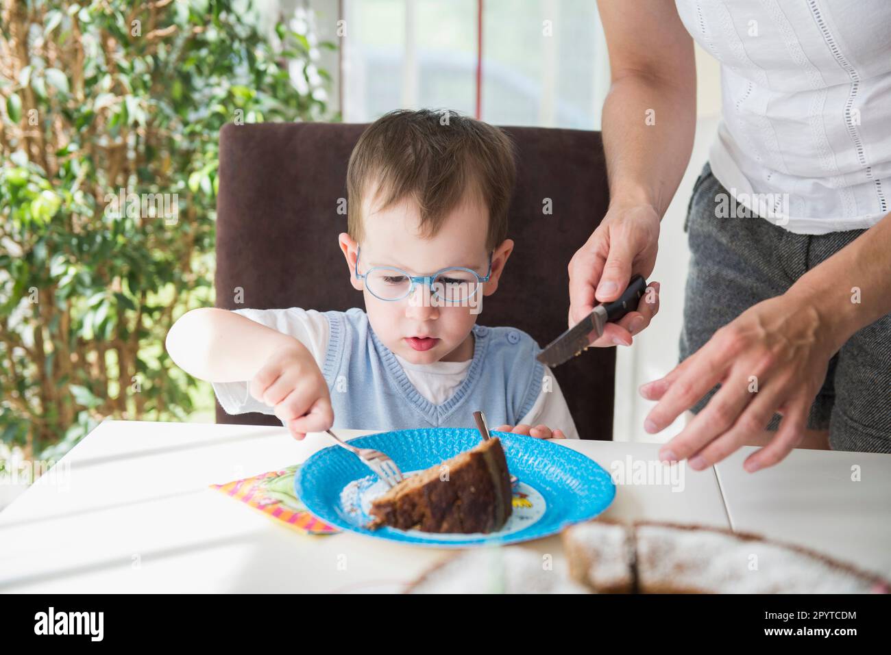 Mother and son having a slice of cake of birthday cake, Bavaria, Germany Stock Photo