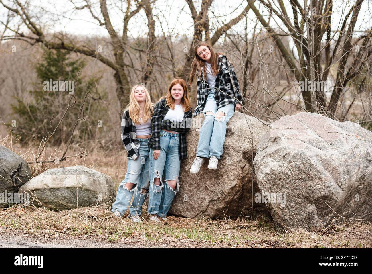 Three happy teen girls hanging out together outdoors. Stock Photo