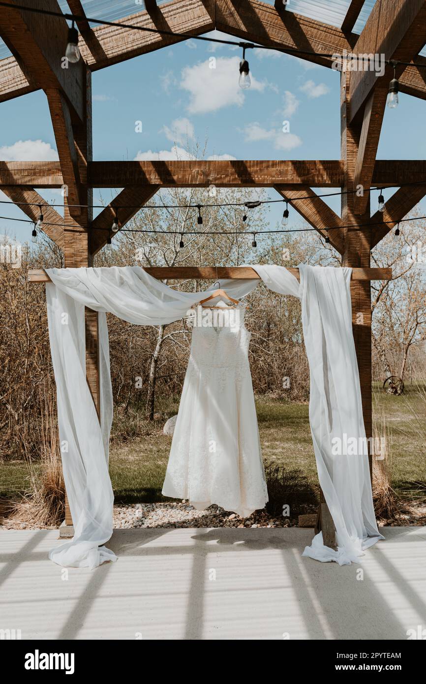 Wedding Dress hanging from the ceremony arbour in spring Stock Photo ...