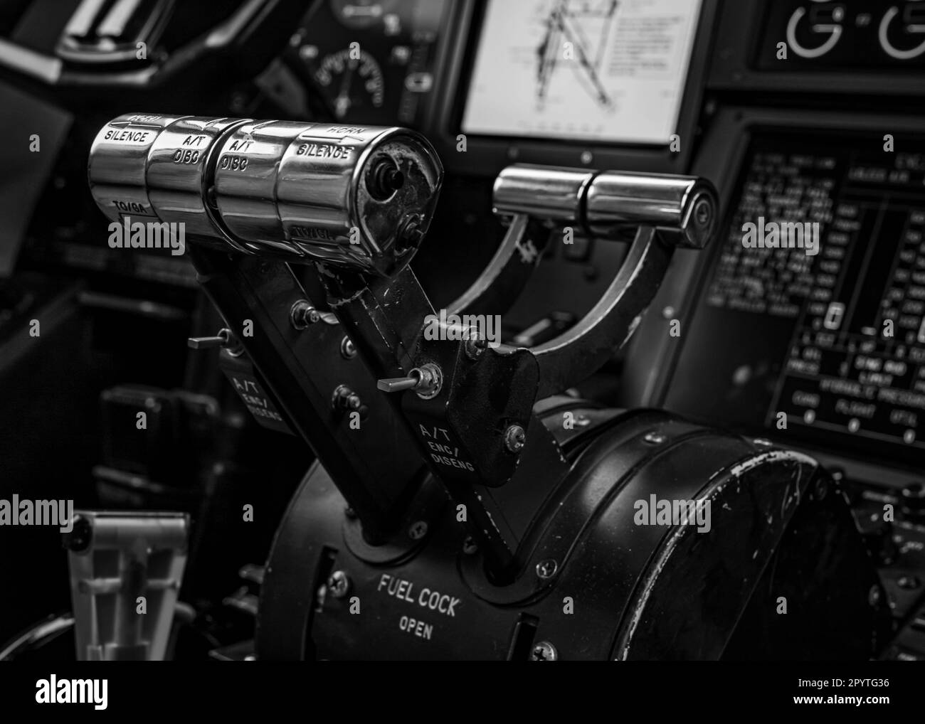 A black and white image of a helicopter cockpit, featuring a variety of electronic instruments and controls Stock Photo