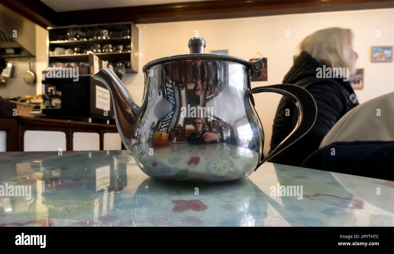Stainless teapot on cafe table Stock Photo Alamy