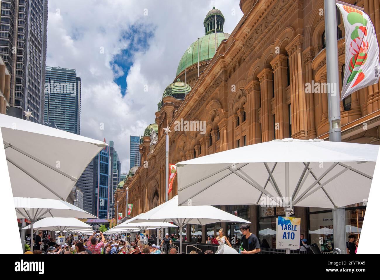 Sydney, Aust, 02 Dec 2022: White cafe umbrellas line George Street beside the stone Queen Victoria Building at the 2nd annual OPEN FOR LUNCH event Stock Photo
