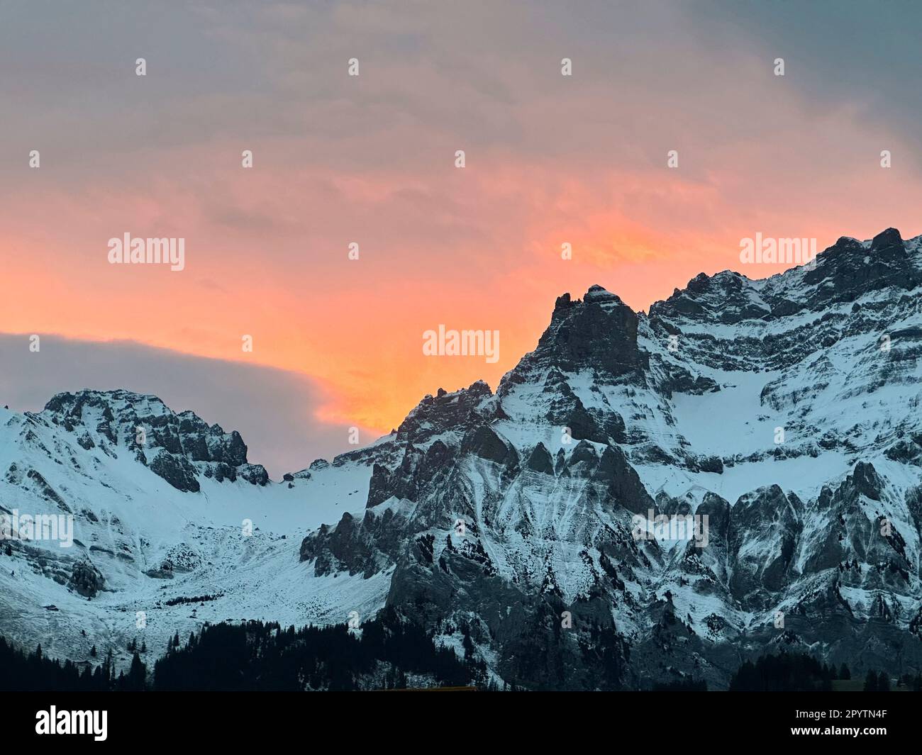 FROM THE SERIES ADELBODEN Mountains in wintry landscape in Adelboden, Bernese Oberland, Canton of Bern, Switzerland. The picturesque town of Adelboden is a Swiss idyll in the Bernese Alps, impressive peaks, unique winter landscape, popular ski area, alpine pastures, rushing waterfalls, cozy wooden houses. Due to climate change and less and less snow, the classic winter sports resort is reorienting itself, and the summer season is becoming more important. Stock Photo