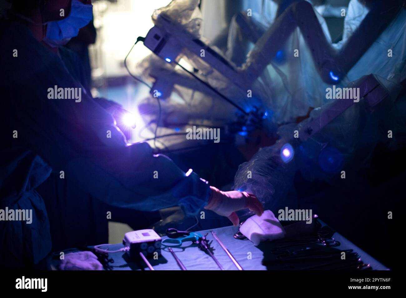 Doctor assists during a modern hybrid surgery, 3D innovative technology with the DaVinci system a robot-assisted surgery KI robotics. Operation of a tumor on the liver and stomach in the University Hospital Carl Gustav Carus, Clinic and Polyclinic for Visceral Surgery, Thoracic Surgery and Vascular Surgery and Center for Tumor Diseases in Dresden, Saxony, Germany. Robot-assisted surgery is a modern surgical procedure in medicine. It enables the surgeon to carry out minimally invasive surgical techniques with the support of the robot-assisted system. Stock Photo