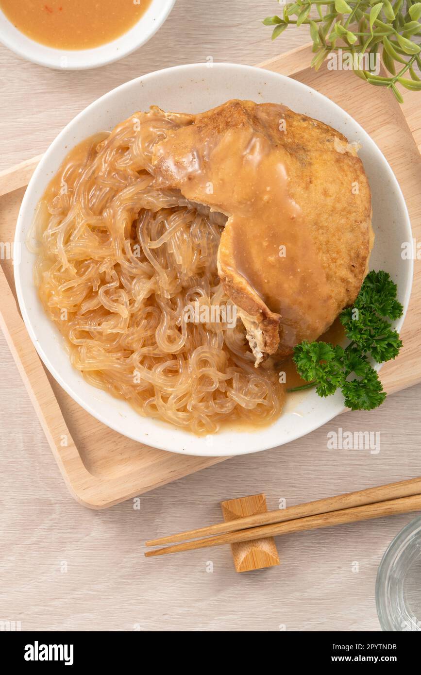 Tamsui agei (age, aburaage, ageh), delicious street food in Taiwan, stuffed with mung bean noodles and sauce topping. Stock Photo