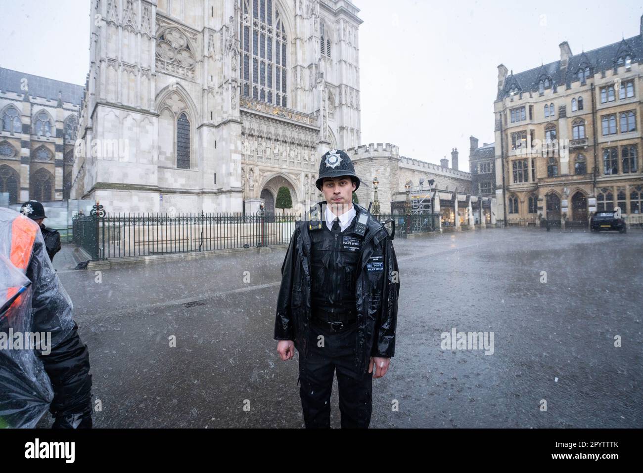 London UK. 5 May 2023. A police officer outside Westminster Abbey is caught in a heavy downpour  a day before the coronation of King Charles III, the biggest ceremonial event staged in the capital for 70 years. Credit: amer ghazzal/Alamy Live News Stock Photo