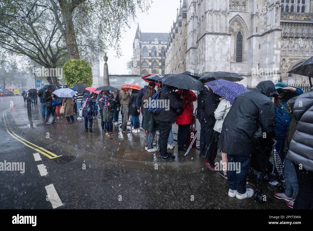 London UK. 5 May 2023. Pedestrians and royal fans are caught in a heavy downpour in Westminster a day before the coronation of King Charles III,  the biggest ceremonial event staged in the capital for 70 years. Credit: amer ghazzal/Alamy Live News Stock Photo