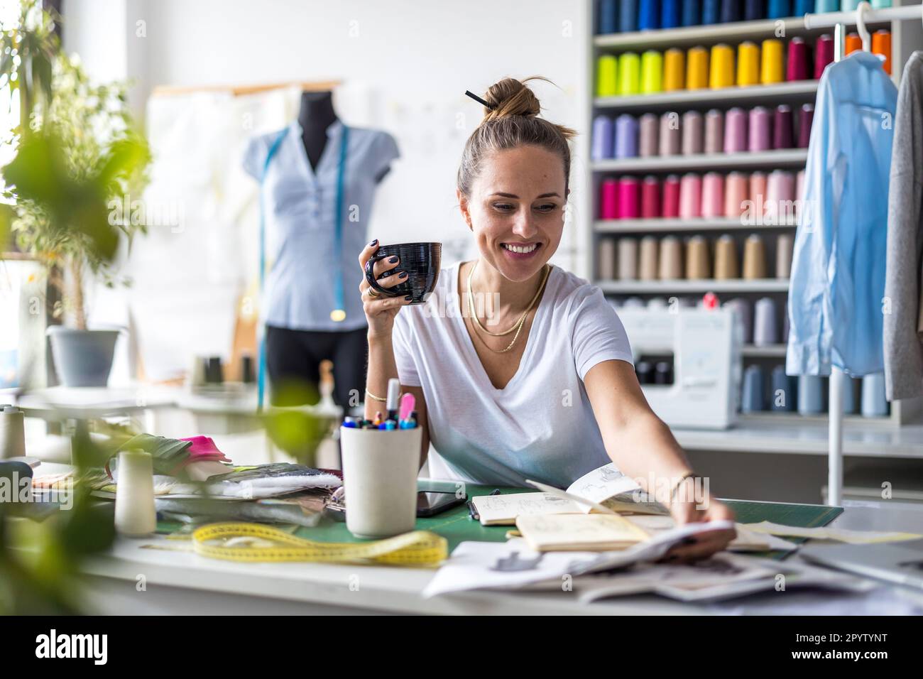 Young fashion designer working at her workplace Stock Photo - Alamy