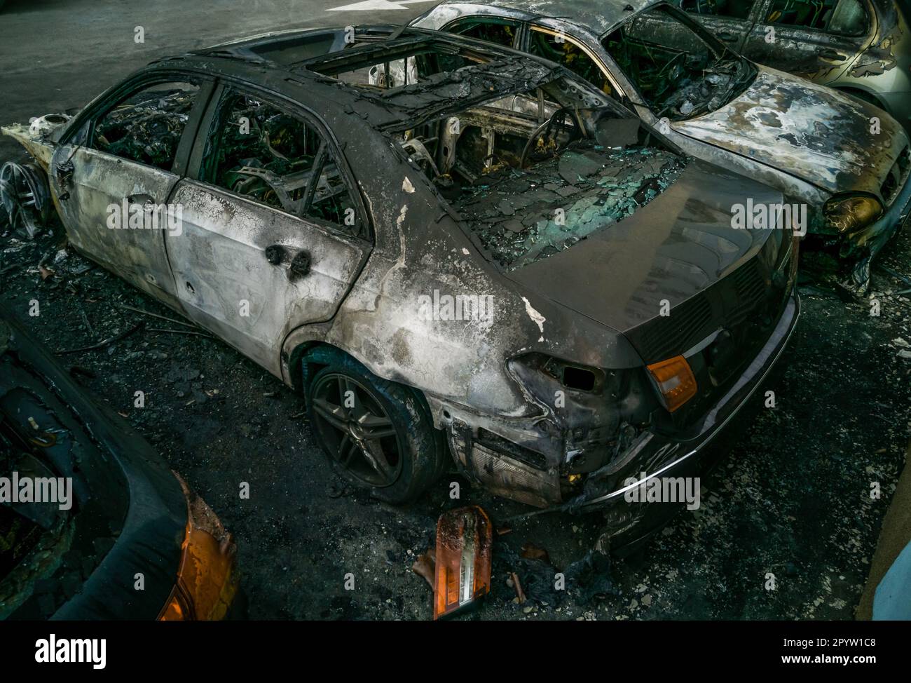 cars after the fire. Two burned out cars with an open hood. Arson ...