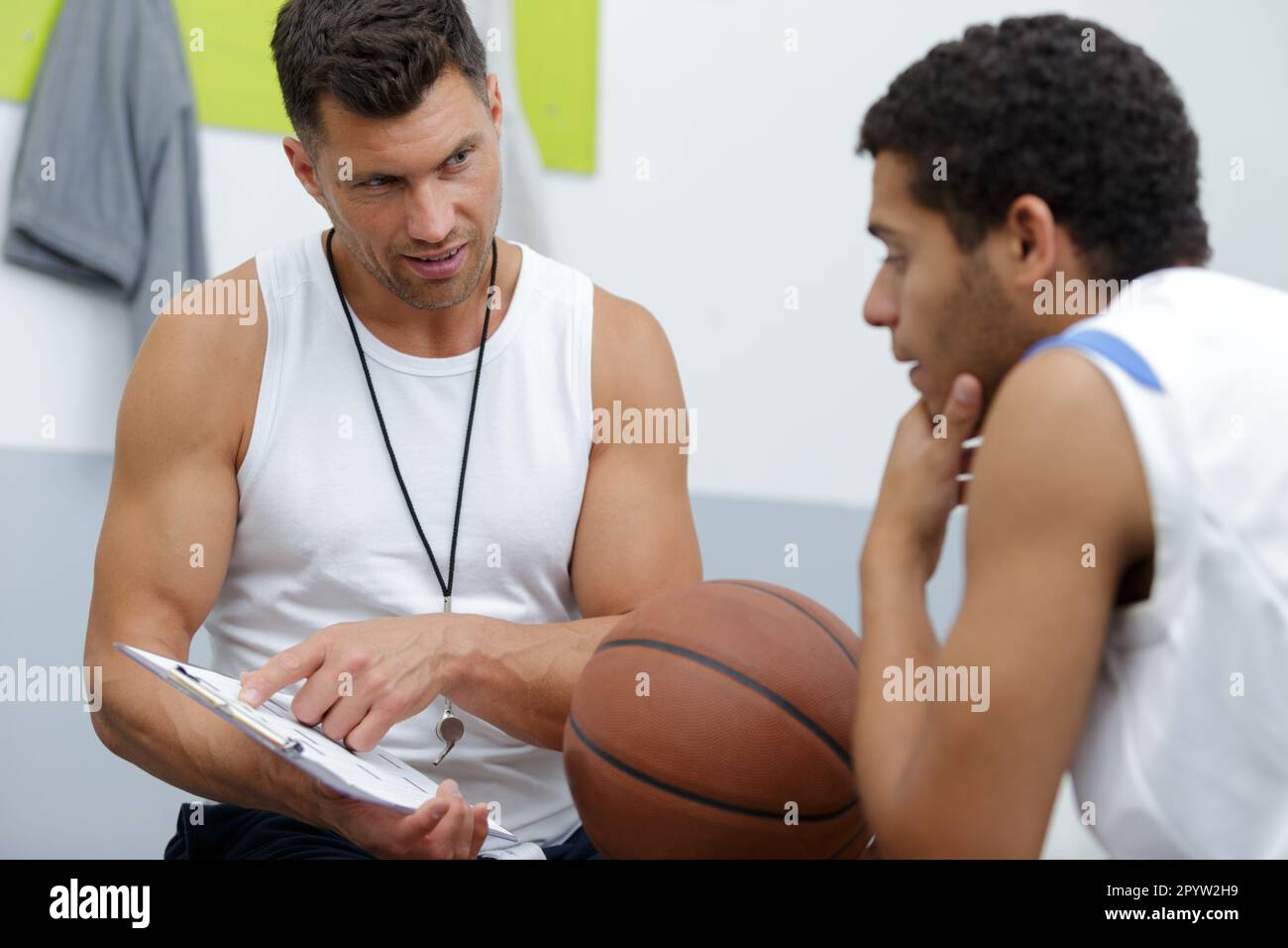 gym teacher with basketball player Stock Photo Alamy