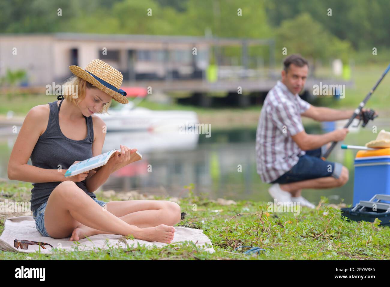 People Rading Fish Man fishing woman reading book hi-res stock photography and images - Alamy