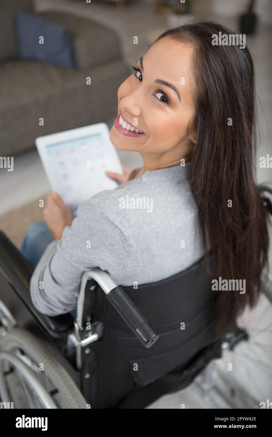 disabled woman in wheelchair at home with tablet pc Stock Photo - Alamy
