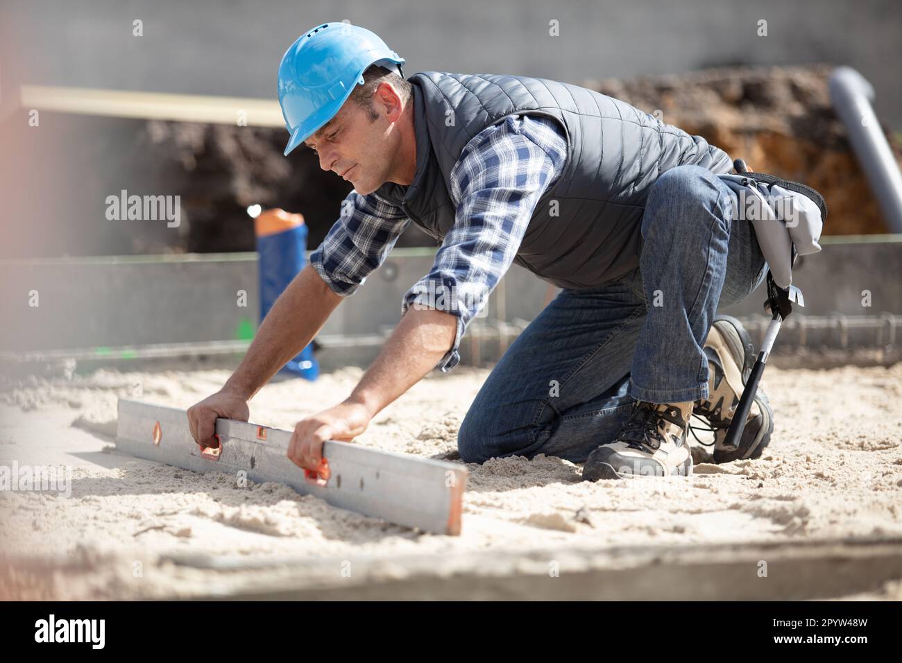 builder leveling floor at site Stock Photo