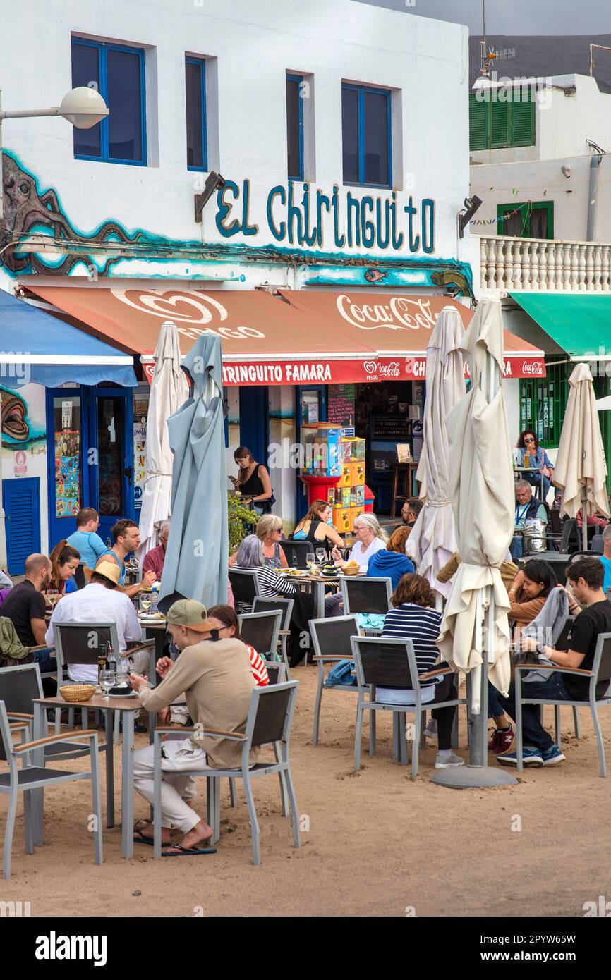 Spain, Canary Islands, Lanzarote island. Caleta de Famara. Sea side restaurant. Outdoor terrace. Stock Photo