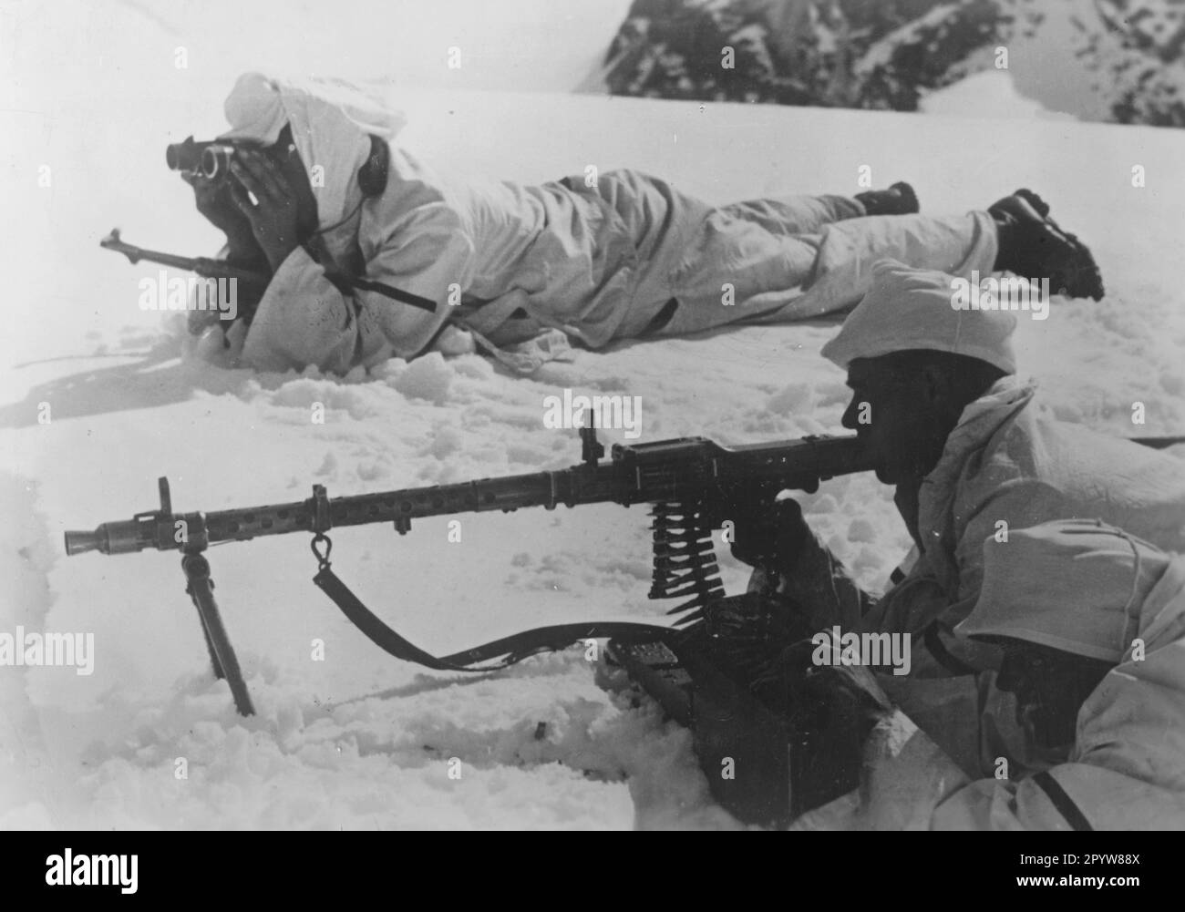 Mountain troops with an MG 34 during combat in the high mountains. Photo: Rieder. [automated translation] Stock Photo