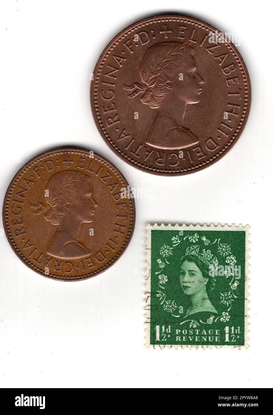 One and a half penny coins and stamp from the reign of Queen Elizabeth II isolated on a white background. Stock Photo