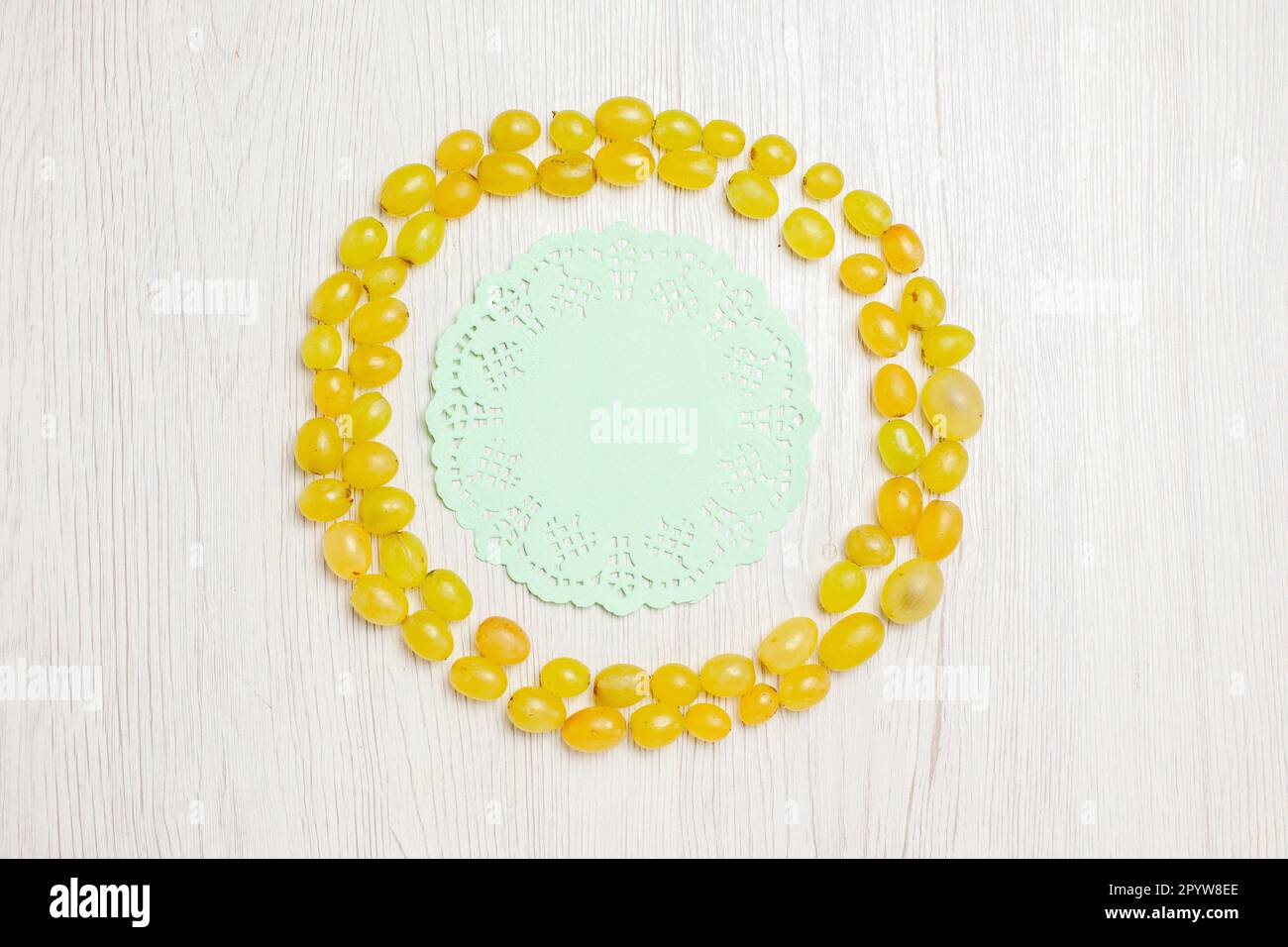 top view fresh green grapes making a circle on white desk fruit wine ...