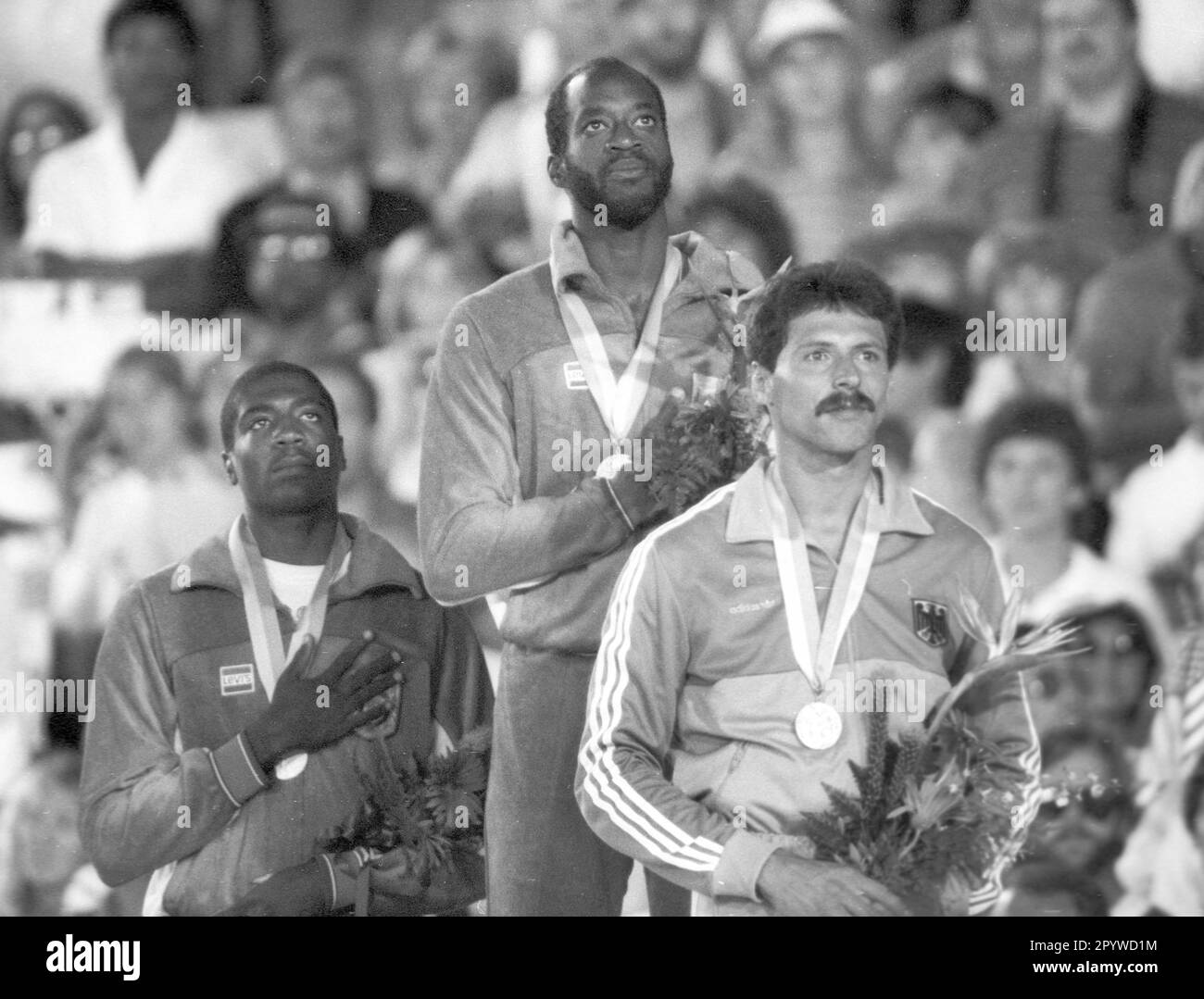 Olympic Games 1984 in Los Angeles. Award ceremony 400m hurdles: Edwin Moses (USA/Gold). Behind: Danny Harris (USA/Silver) in front: Harald Schmid (BRD/Bronze) 05.08.1984. [automated translation] Stock Photo