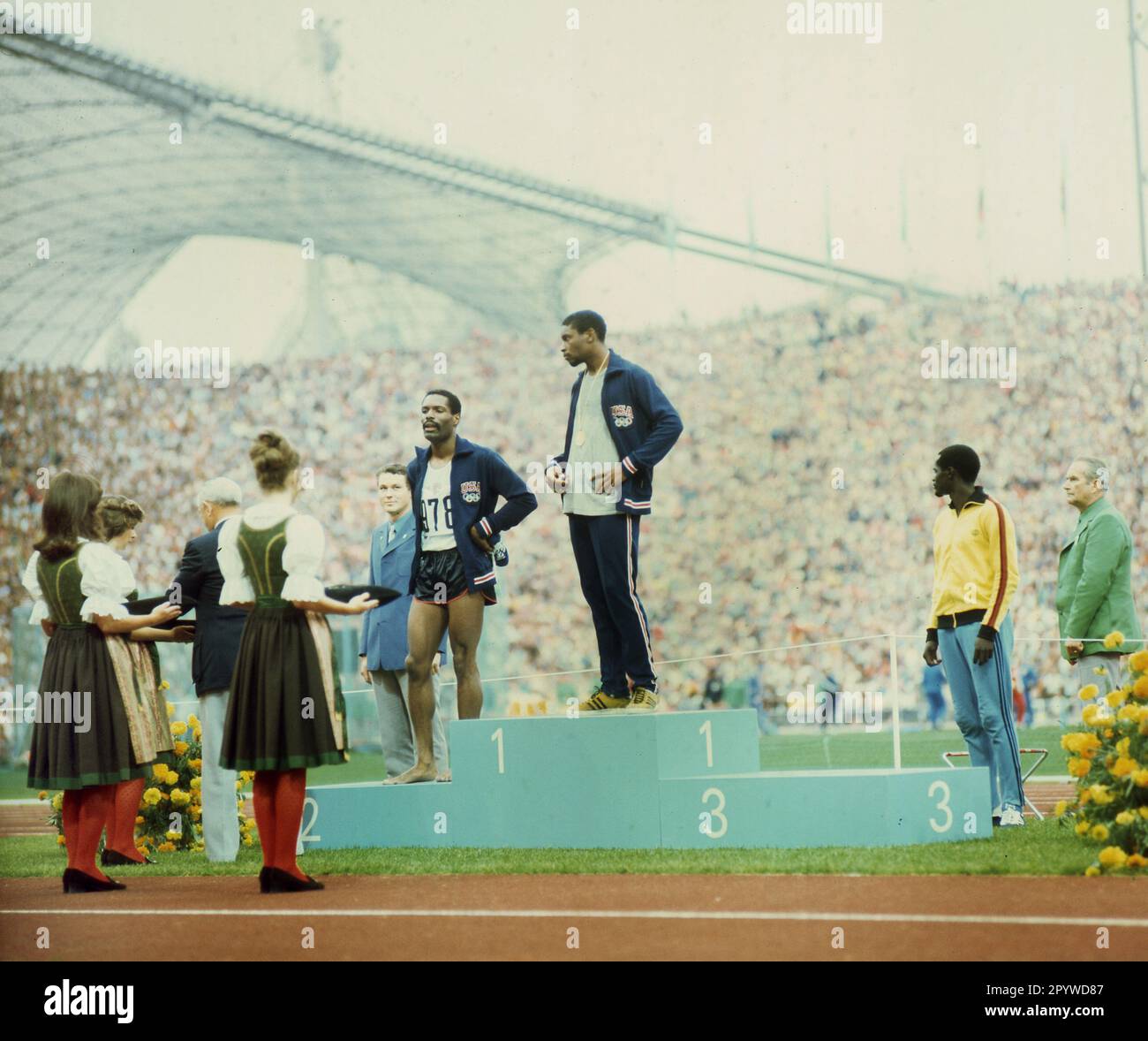 Olympic Games Munich 1972: Award ceremony 400m : Vince Matthews (gold) and Wayne Collett (silver/both USA) with disrespectful appearance at the award ceremony. Wayne Collett with barefoot. Right: Julius Sang (Kenya/Bronze) 07.09.1972. [automated translation] Stock Photo