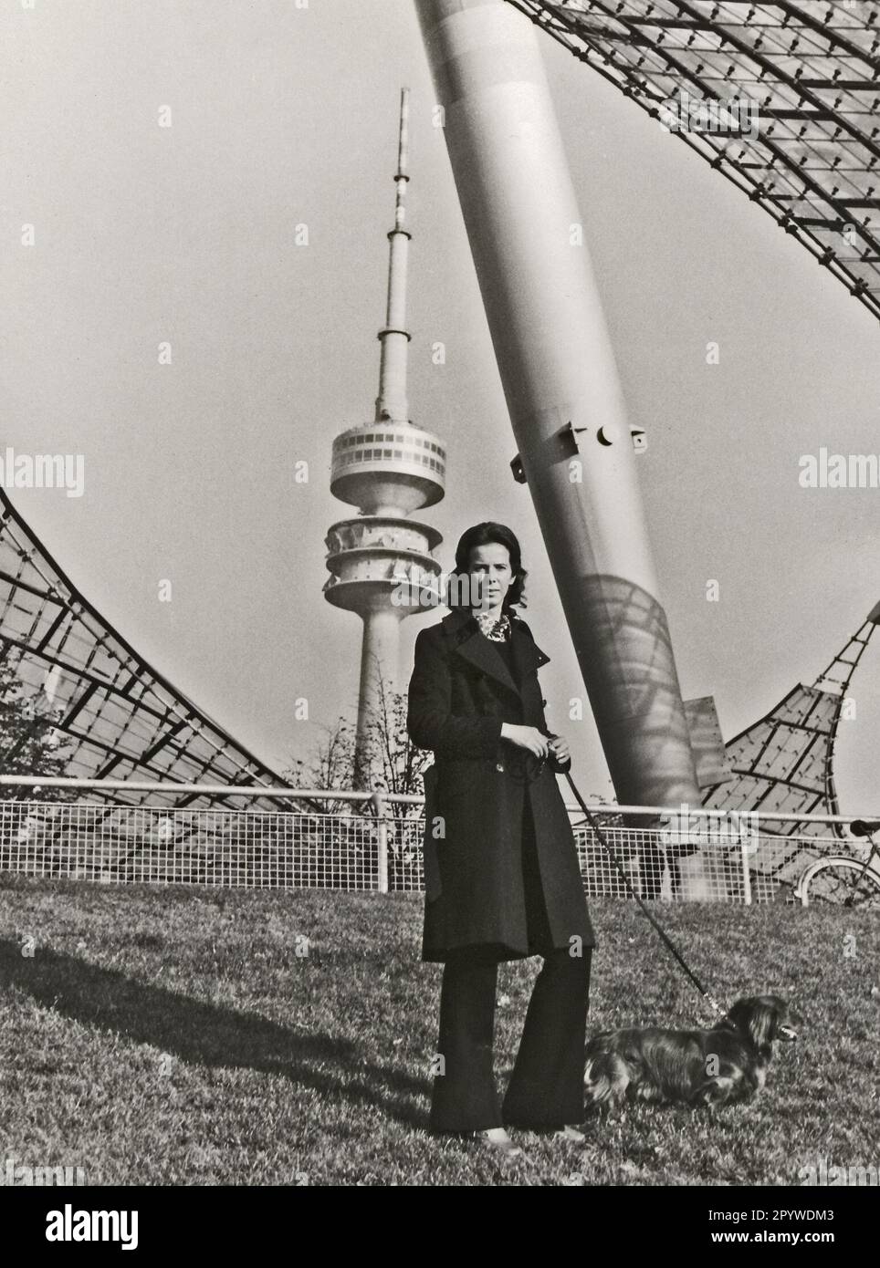 Woman with dachshund on the tent roof of the stadium. [automated